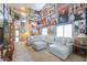 Bright living room featuring a high ceiling, large sofa, and unique wall art at 44890 W Desert Garden Rd, Maricopa, AZ 85139