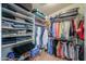 Organized walk-in closet with shelves, hanging rods, and plenty of space for clothing and luggage at 44890 W Desert Garden Rd, Maricopa, AZ 85139