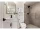 Modern bathroom showcasing a stylish vanity, arched mirror, contemporary fixtures, and walk-in shower with dark gray tile at 510 N Entrada St, Chandler, AZ 85226