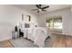 Bright bedroom features a ceiling fan, neutral decor, and sliding glass door to the backyard at 510 N Entrada St, Chandler, AZ 85226