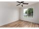 A simple room with a ceiling fan and a large window with a view of a truck in the neighborhood at 510 N Entrada St, Chandler, AZ 85226