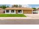 Charming single-story home with a manicured lawn, tan siding, and a tan colored roof at 510 N Entrada St, Chandler, AZ 85226