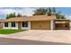 Charming single-story home with a manicured lawn and a light colored roof at 510 N Entrada St, Chandler, AZ 85226