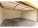 View of the garage showcasing multiple doors, a concrete floor, and lighting at 510 N Entrada St, Chandler, AZ 85226