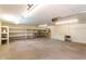 Spacious garage featuring shelving, concrete floor, fluorescent lighting, and ample room for storage at 510 N Entrada St, Chandler, AZ 85226