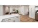 Open-concept kitchen featuring white cabinets, quartz countertops, stainless steel appliances, and modern finishes with dining area at 510 N Entrada St, Chandler, AZ 85226