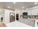 A beautifully designed kitchen with stainless steel appliances, ample counter space, and white cabinets with modern hardware at 510 N Entrada St, Chandler, AZ 85226