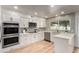 Beautiful white kitchen with modern stainless steel appliances and light-colored flooring at 510 N Entrada St, Chandler, AZ 85226