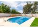 Backyard pool surrounded by mature trees and lush artificial turf at 510 N Entrada St, Chandler, AZ 85226