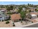 A sunny aerial view of a single story home with desert landscaping and a two car garage in a well-kept community at 6725 E Kings Ave, Scottsdale, AZ 85254