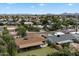 An aerial view showcases residential area with well-kept homes, lush trees, and community landscaping at 6725 E Kings Ave, Scottsdale, AZ 85254
