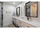 Bathroom with dual sinks, white cabinets, and modern fixtures at 6725 E Kings Ave, Scottsdale, AZ 85254
