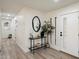 A well-lit foyer with neutral walls and flooring, modern console table and decor creating an inviting entrance at 6725 E Kings Ave, Scottsdale, AZ 85254