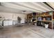 Spacious two-car garage with built-in shelving, laundry area, and ample storage space at 6725 E Kings Ave, Scottsdale, AZ 85254