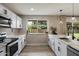 Modern kitchen features white cabinets, white countertops and stainless steel appliances at 6725 E Kings Ave, Scottsdale, AZ 85254
