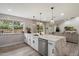 A modern kitchen with white cabinets, quartz countertops and stainless steel appliances at 6725 E Kings Ave, Scottsdale, AZ 85254
