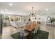 Open-concept kitchen and dining area with a large island, modern lighting, and hardwood floors at 6725 E Kings Ave, Scottsdale, AZ 85254