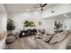 Bright living room features a ceiling fan, light wood floors, neutral paint, and comfortable seating at 6725 E Kings Ave, Scottsdale, AZ 85254