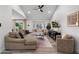 Bright living room with high ceilings, a ceiling fan, a comfortable sectional sofa, and a large bay window at 6725 E Kings Ave, Scottsdale, AZ 85254