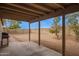 View of backyard with a covered patio, gravel, mature trees, and block wall at 7019 S 19Th Pl, Phoenix, AZ 85042