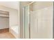 Bright bathroom featuring a tiled shower with glass door and a separate soaking tub at 7019 S 19Th Pl, Phoenix, AZ 85042