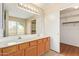 Bathroom features double sinks with modern vanity and large well-lit mirror, and closet at 7019 S 19Th Pl, Phoenix, AZ 85042