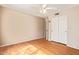 Bedroom with wood-look flooring, ceiling fan, and sliding closet doors at 7019 S 19Th Pl, Phoenix, AZ 85042