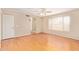 Bright bedroom with hardwood floors, fan, ensuite bathroom and window for natural light at 7019 S 19Th Pl, Phoenix, AZ 85042
