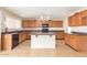 Bright kitchen with wooden cabinets, a central island, and modern appliances at 7019 S 19Th Pl, Phoenix, AZ 85042