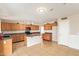 Well-equipped kitchen features wood cabinetry, black appliances, kitchen island, and tile flooring at 7019 S 19Th Pl, Phoenix, AZ 85042