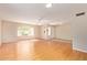 Bright and spacious living room with wood floors, ceiling fan, and view into the entrance at 7019 S 19Th Pl, Phoenix, AZ 85042