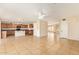 Expansive living area featuring an open-concept design with tile flooring, and a seamless transition to the kitchen at 7019 S 19Th Pl, Phoenix, AZ 85042