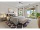 Bright bedroom with a plush bed, balcony access, and serene views of the outdoors at 7262 E Lupine Ave, Scottsdale, AZ 85260
