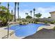 Private backyard pool with a rock waterfall feature and lush tropical landscaping at 7262 E Lupine Ave, Scottsdale, AZ 85260