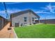 Well-maintained backyard featuring artificial turf, string lights, and a covered patio at 7751 W Miami St, Phoenix, AZ 85043