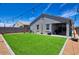 Spacious backyard with lush artificial turf, ideal for outdoor entertaining and play at 7751 W Miami St, Phoenix, AZ 85043
