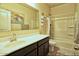 Bathroom with a white sink, vanity, mirror, and a shower/tub combination with a shower curtain at 7751 W Miami St, Phoenix, AZ 85043