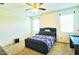 A stylish bedroom with a tufted headboard bed, carpeting, and natural light from the window at 7751 W Miami St, Phoenix, AZ 85043