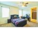 Bright bedroom with a vanity area and natural light, featuring soft carpeting and a comfortable bed at 7751 W Miami St, Phoenix, AZ 85043