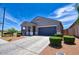 Well-manicured lawn and tidy landscaping complement this cozy single-level home with an attached garage at 7751 W Miami St, Phoenix, AZ 85043