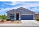 Charming single-story home featuring a well-maintained front yard and a two-car garage at 7751 W Miami St, Phoenix, AZ 85043