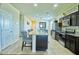 Modern kitchen features stainless steel appliances, granite island, and tile flooring at 7751 W Miami St, Phoenix, AZ 85043
