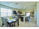 Open-concept kitchen features stainless steel appliances, a granite island, and a dining table set at 7751 W Miami St, Phoenix, AZ 85043