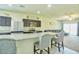 Bright kitchen boasts stainless steel appliances, granite countertops, and seamless flow into the living area at 7751 W Miami St, Phoenix, AZ 85043