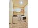 Functional laundry room with washer, dryer, shelving, and tile flooring for convenient chores at 7751 W Miami St, Phoenix, AZ 85043