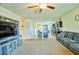 Spacious living room featuring plush carpeting and an open layout to the dining and kitchen areas at 7751 W Miami St, Phoenix, AZ 85043