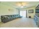 Inviting living space with plush carpeting, a comfortable sofa, and lots of natural light at 7751 W Miami St, Phoenix, AZ 85043