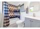 Well-lit bathroom with a tiled shower-tub combination, a toilet, and a vanity with sink at 8140 E Mitchell Dr, Scottsdale, AZ 85251