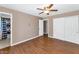 Bedroom featuring wood floors, a ceiling fan, and a closet with sliding doors at 8140 E Mitchell Dr, Scottsdale, AZ 85251