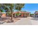 Charming brick home featuring mature trees, a covered carport and a well maintained yard at 8140 E Mitchell Dr, Scottsdale, AZ 85251